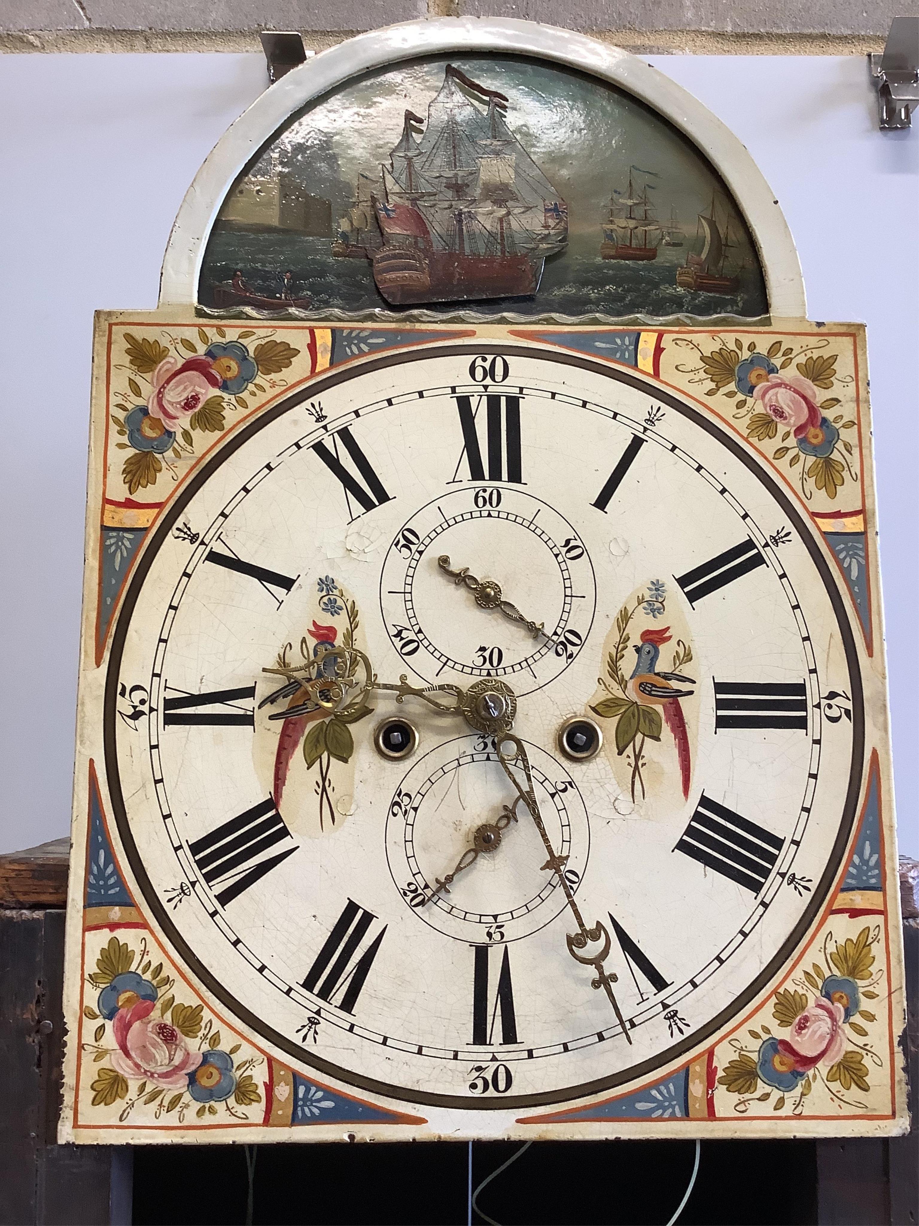 An early 19th century inlaid mahogany North Country eight day longcase clock, the arched painted dial with a ‘‘rocking’’ ship, height 240cm. Condition - fair, door lacks a section of moulding